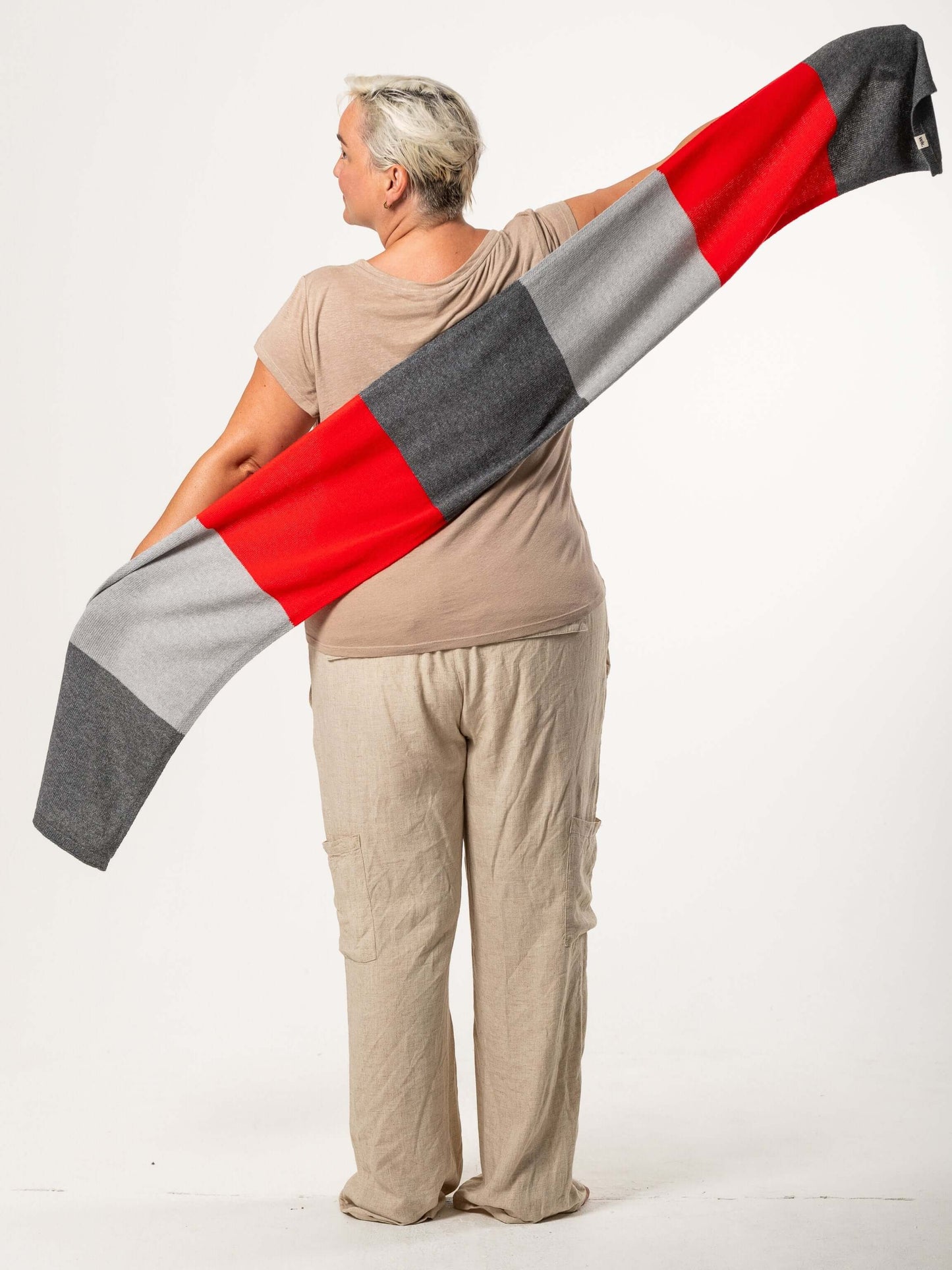 white woman wearing a red and grey merino wool scarf - Woolkind