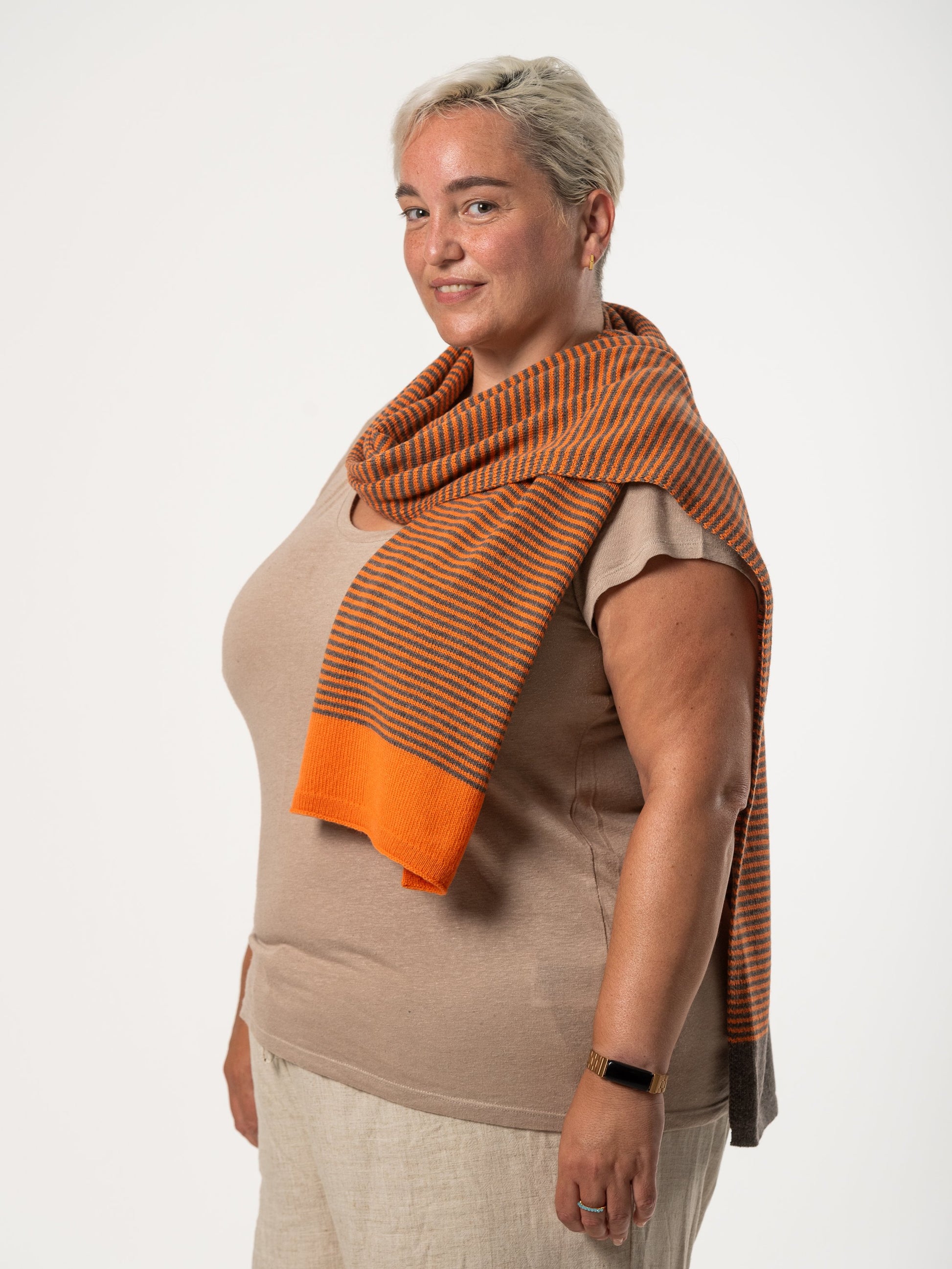 woman wearing merino wool orange and brown stripe scarf - Woolkind