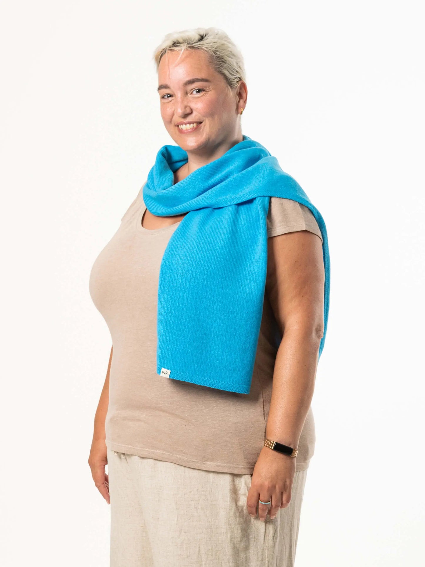 White woman wearing a lightweight quality blue merino wool scarf - woolkind