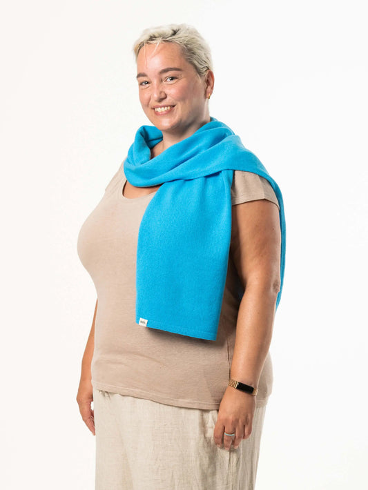 White woman wearing a lightweight quality blue merino wool scarf - woolkind