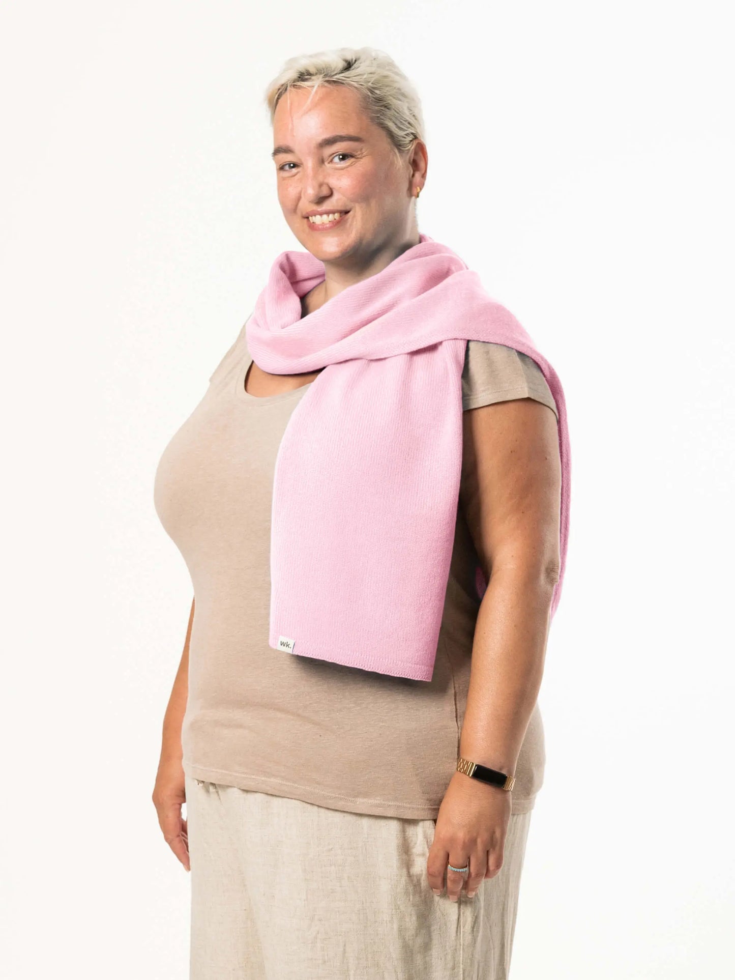 White woman wearing a lightweight quality pink merino wool scarf - woolkind
