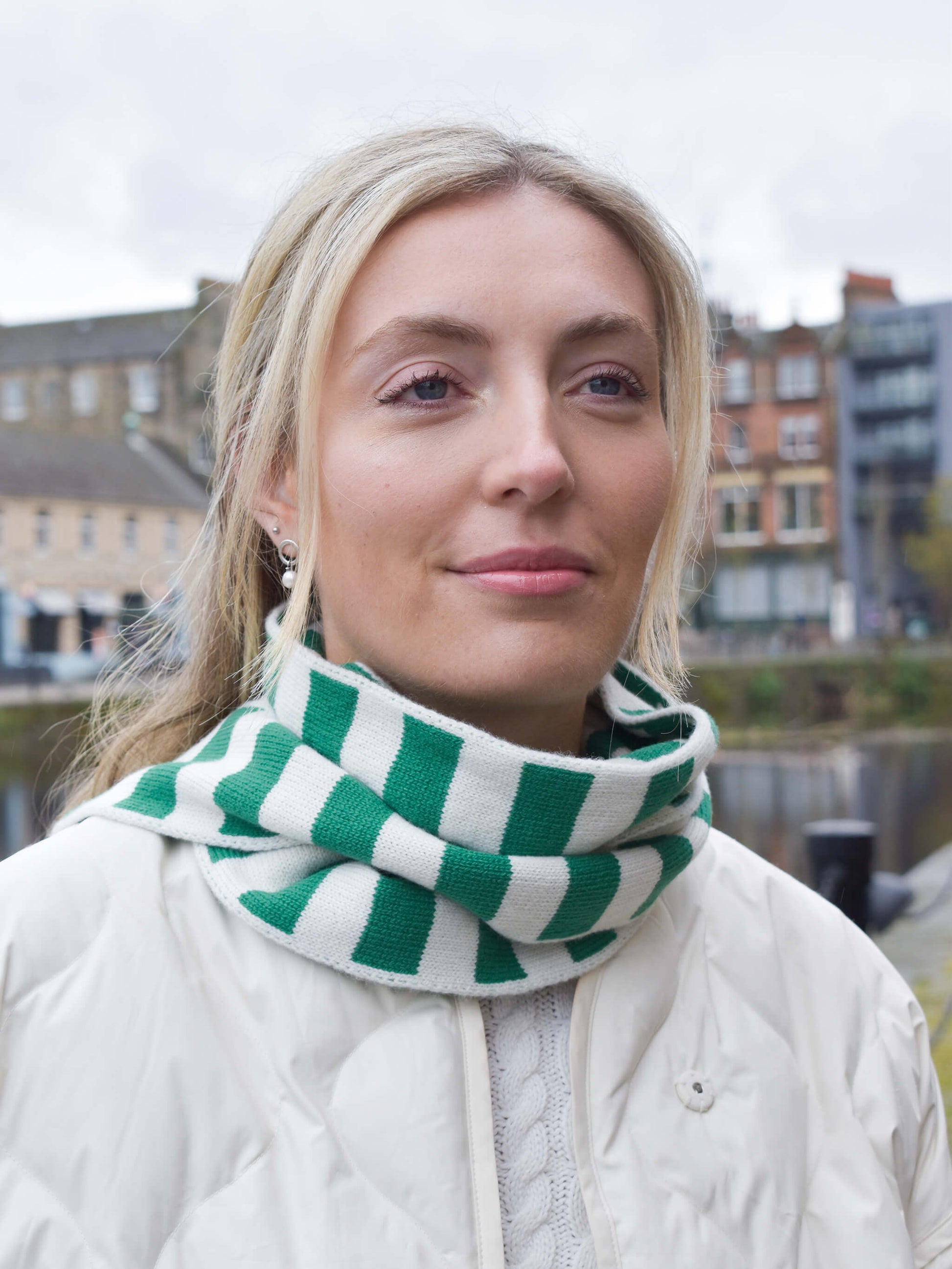 white woman wearing green and cream skinny merino wool stripe scarf - Woolkind