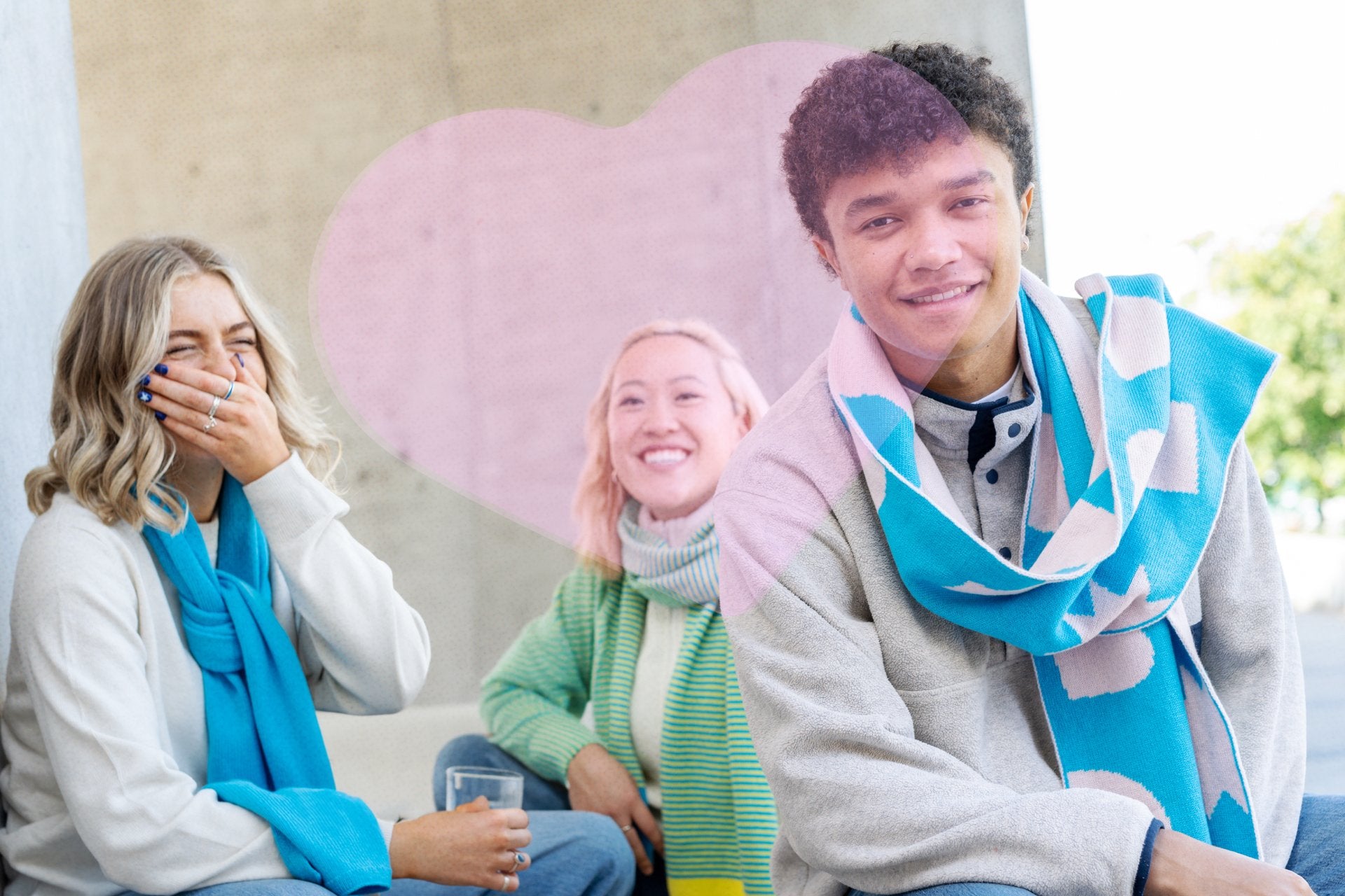 three people sitting on a bench wearing custom merino wool knitted scarves