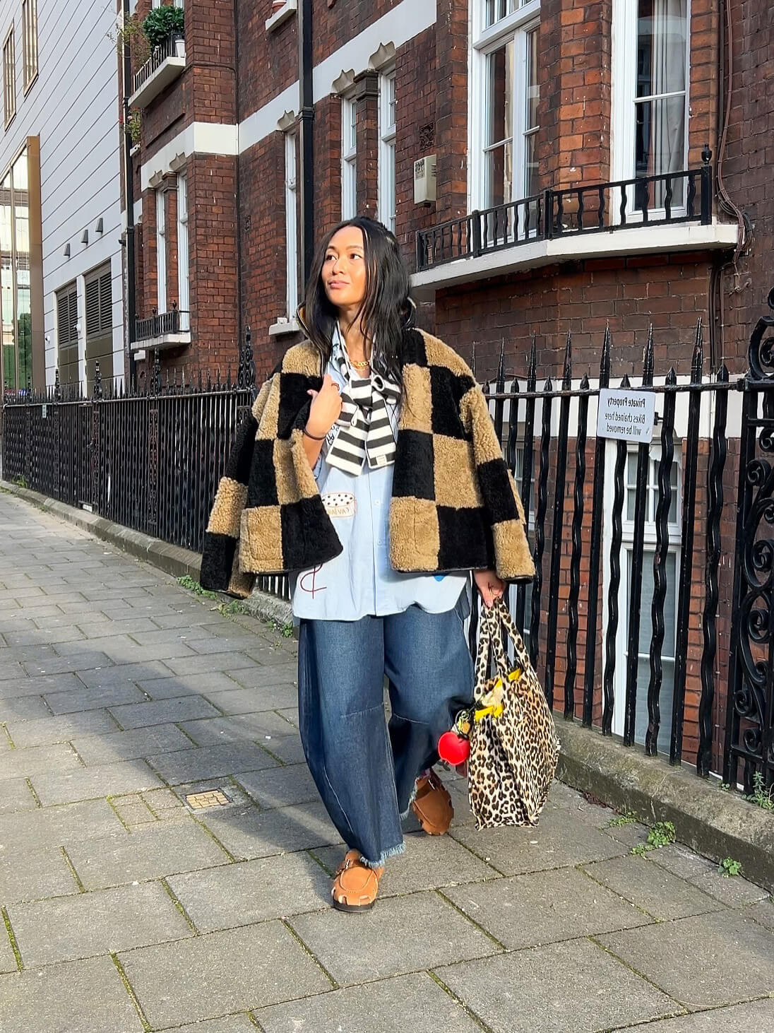 woman wearing skinny thin wool striped scarf in black and cream