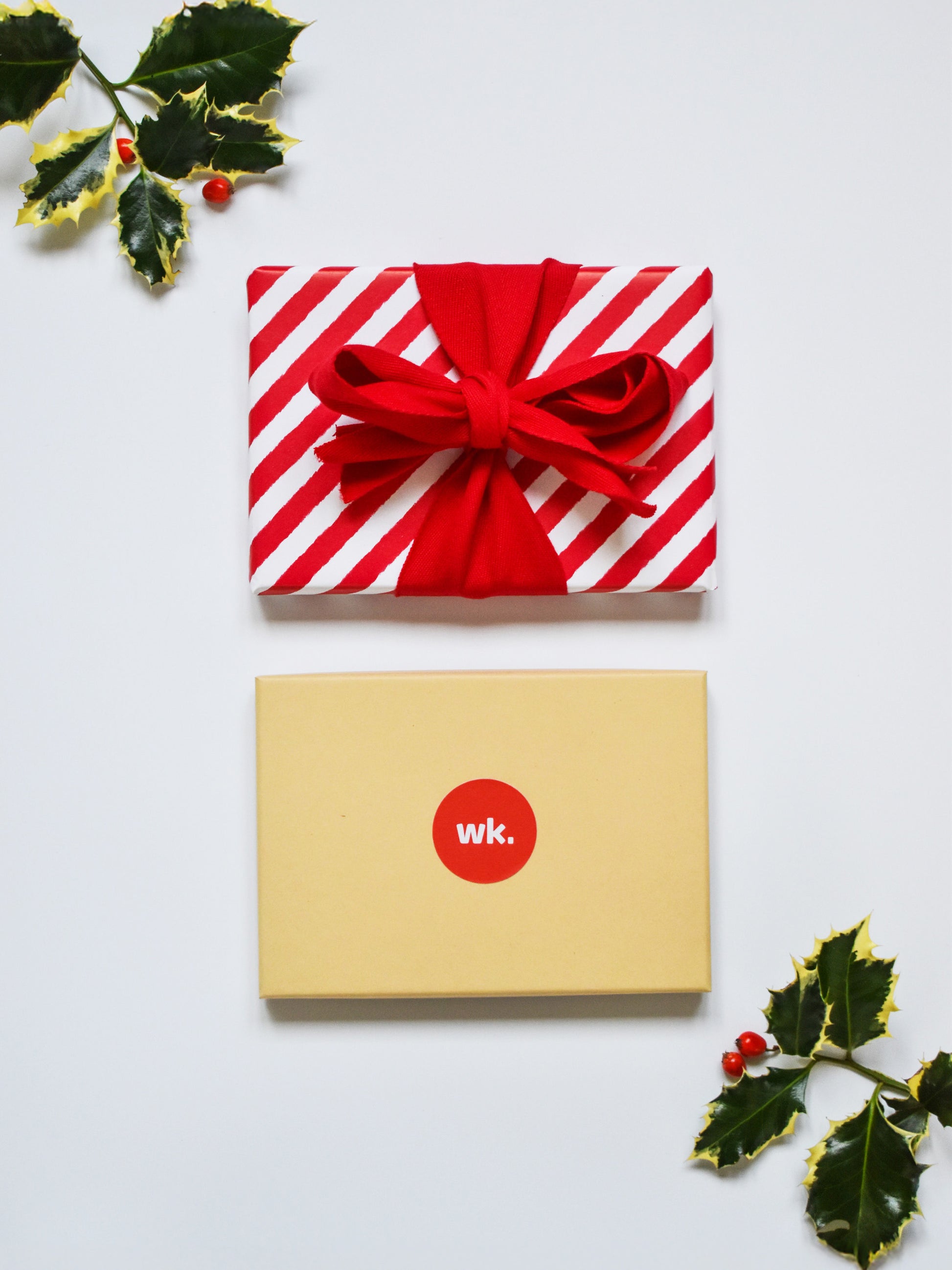 Physical woolkind gift box wrapped in paper and a bow ready for a Christmas present