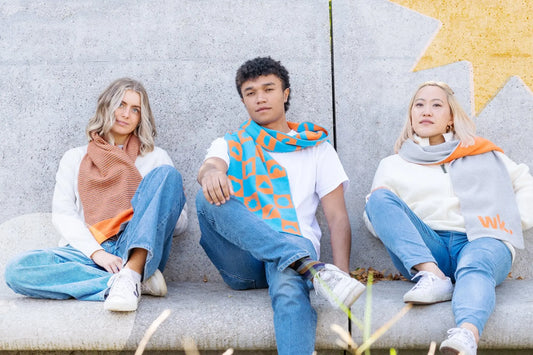 three friends sitting on a bench wearing merino wool scarves - Woolkind