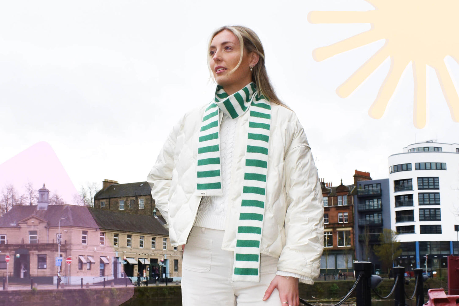 white woman wearing a green a cream striped merino wool skinny scarf