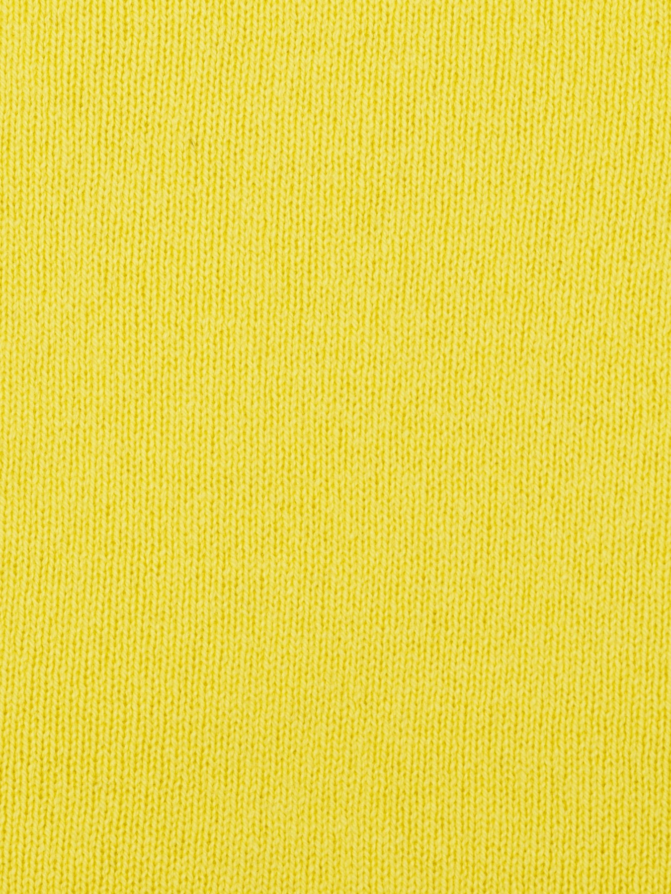 a swatch of plain single jersey knitting made from fine merino wool in a yellow colour