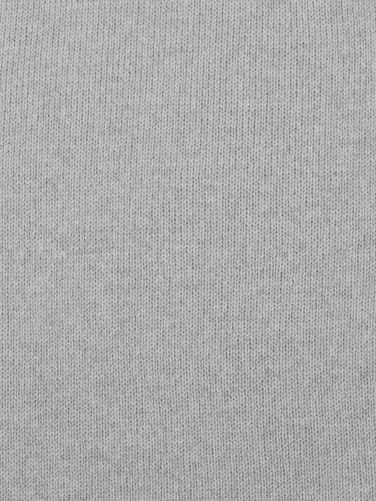 a swatch of plain single jersey knitting made from fine merino wool in a light grey colour