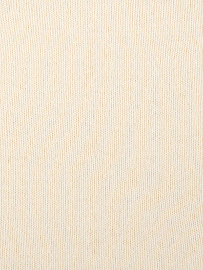 a swatch of plain single jersey knitting made from fine merino wool in a cream colour