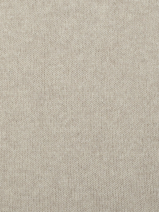 a swatch of plain single jersey knitting made from fine merino wool in a light brown colour