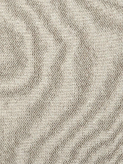 a swatch of plain single jersey knitting made from fine merino wool in a light brown colour