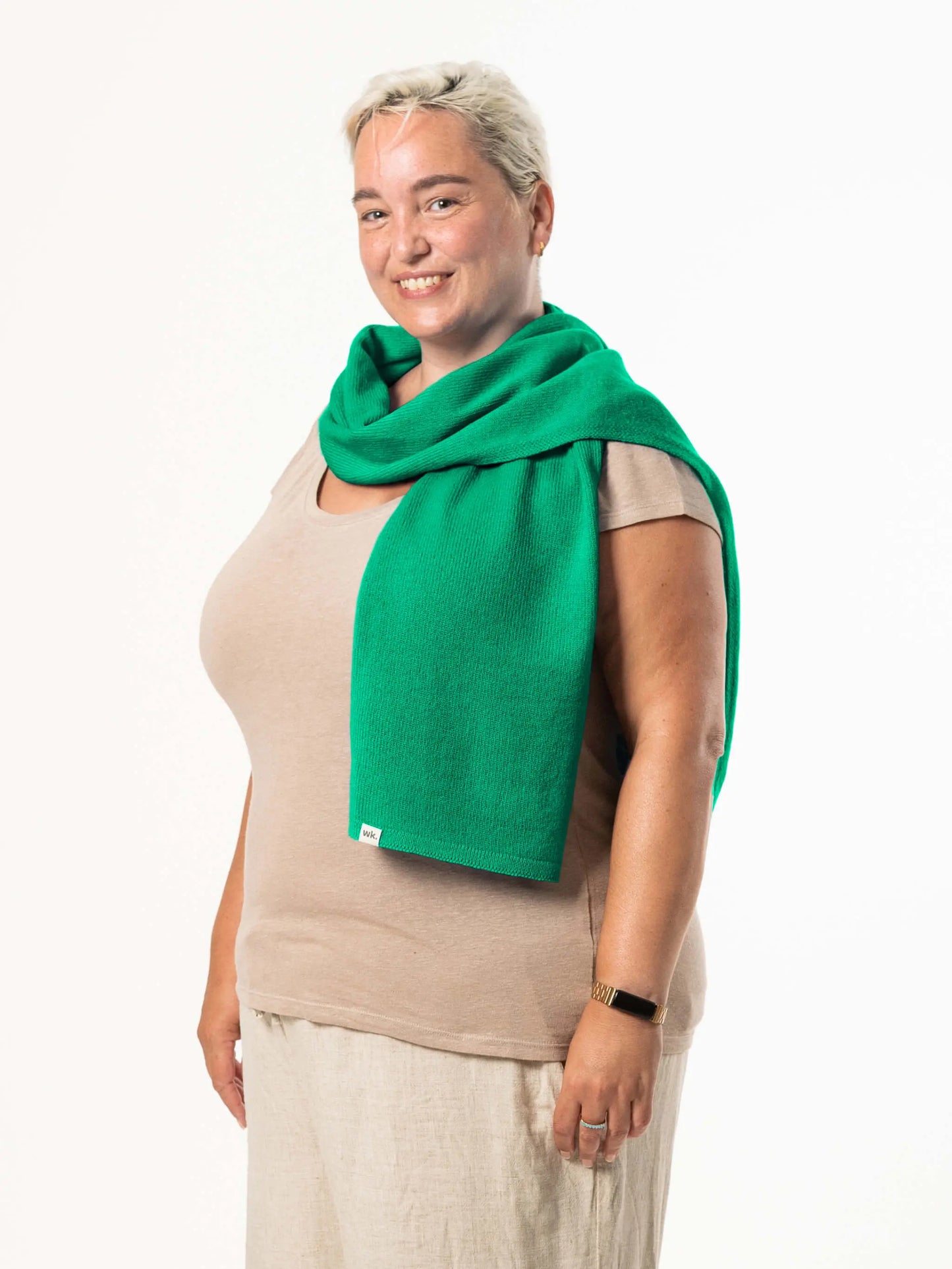 White woman wearing a lightweight quality green merino wool scarf - woolkind