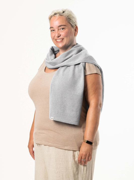 White woman wearing a lightweight quality light grey merino wool scarf - woolkind