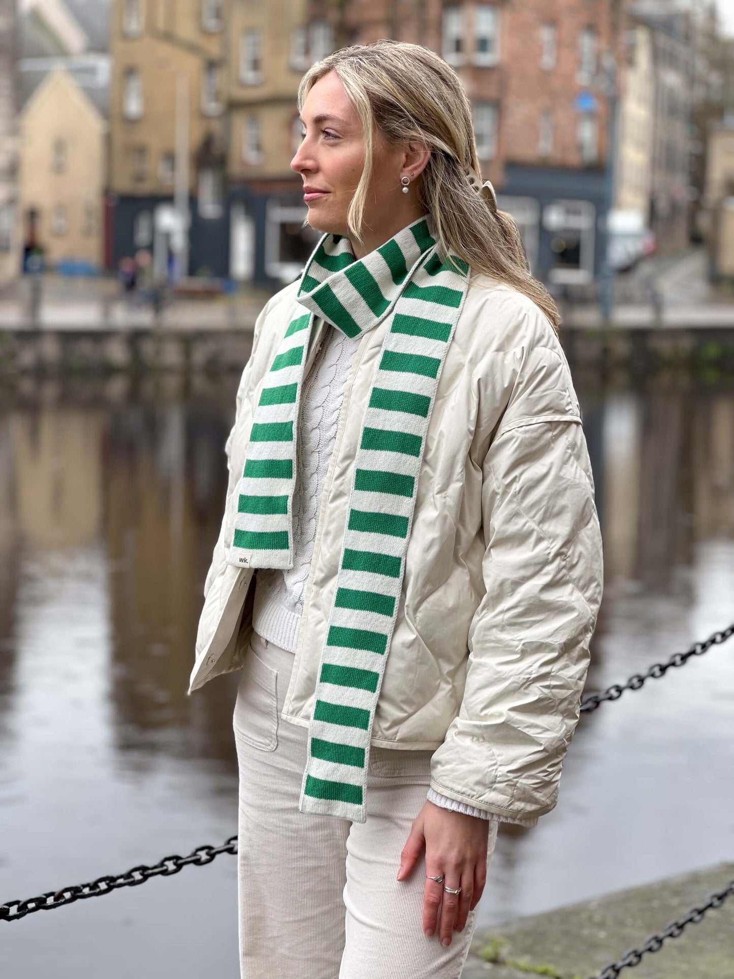 white woman wearing green and cream skinny merino wool stripe scarf - Woolkind