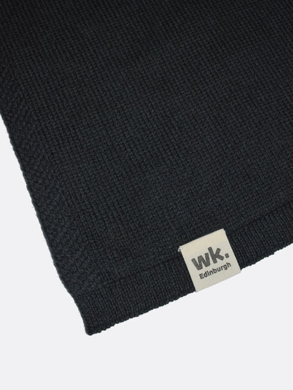 a swatch of plain single jersey knitting made from fine merino wool in a black colour