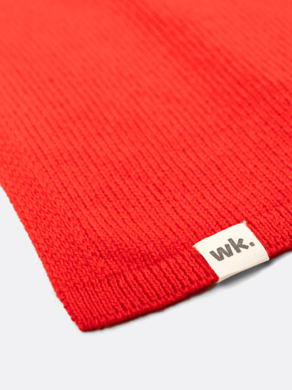 a swatch of plain single jersey knitting made from fine merino wool in a red colour