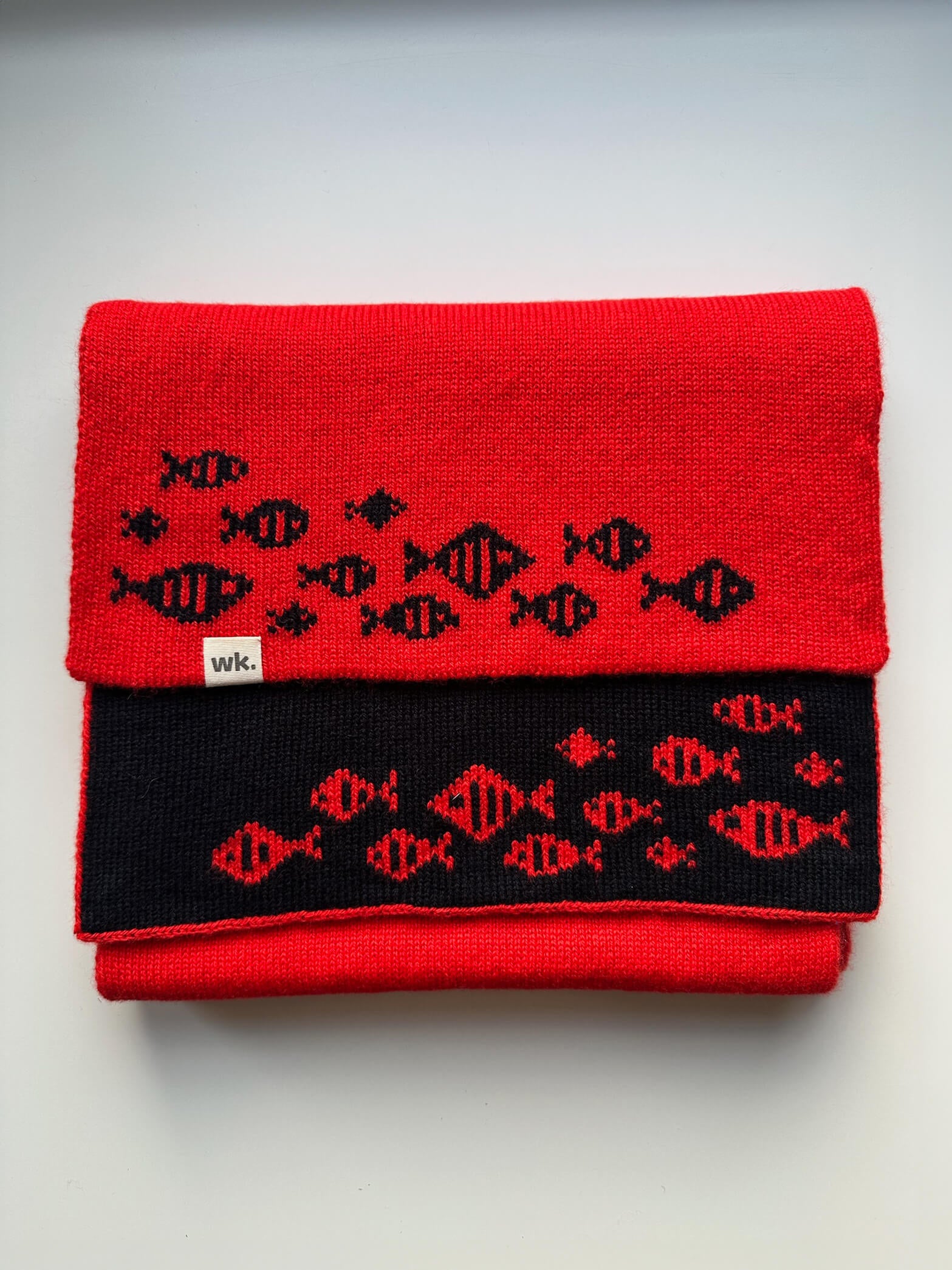 custom reversible merino wool scarf in red with dark navy fish at either end