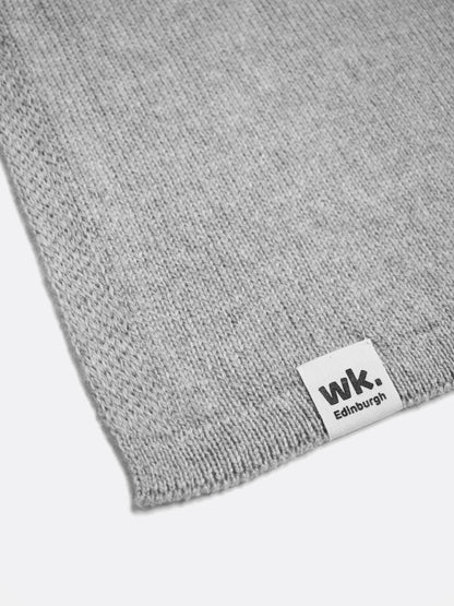 a swatch of plain single jersey knitting made from fine merino wool in a light grey colour