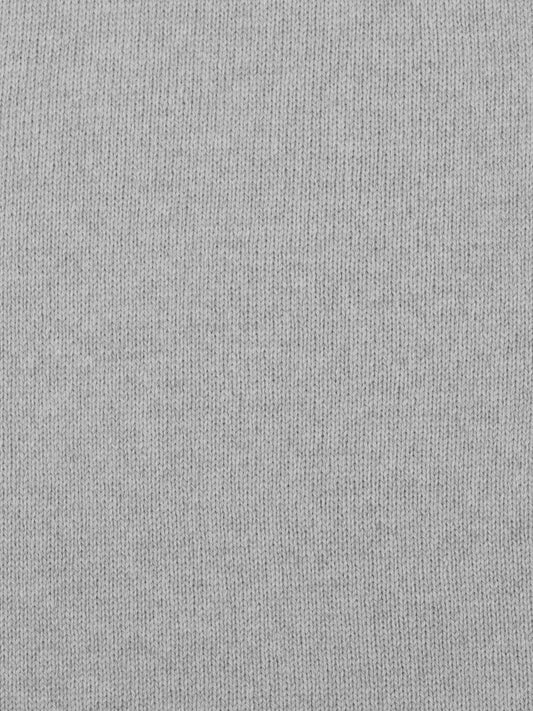 a swatch of plain single jersey knitting made from fine merino wool in a light grey colour