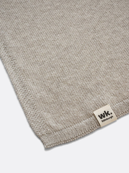 a swatch of plain single jersey knitting made from fine merino wool in a beige colour