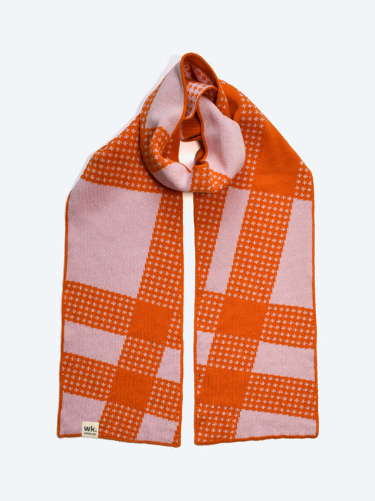 Orange and pink merino wool tartan checkered scarf on a white background