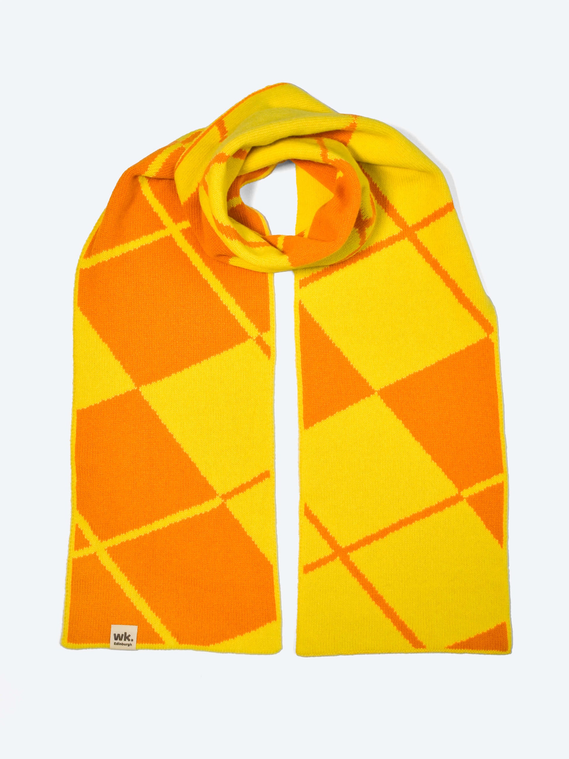 Yellow and orange argyle merino wool scarf on a white background