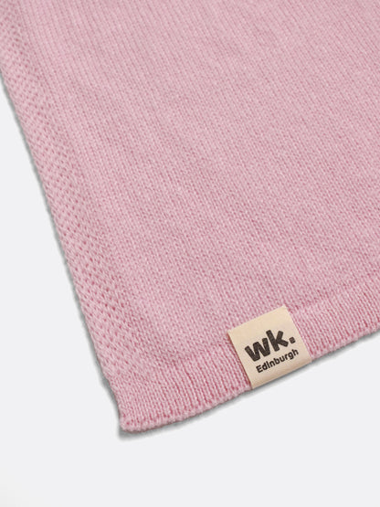 a swatch of plain single jersey knitting made from fine merino wool in a pale pink colour