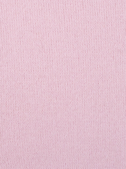 a swatch of plain single jersey knitting made from fine merino wool in a pale pink colour