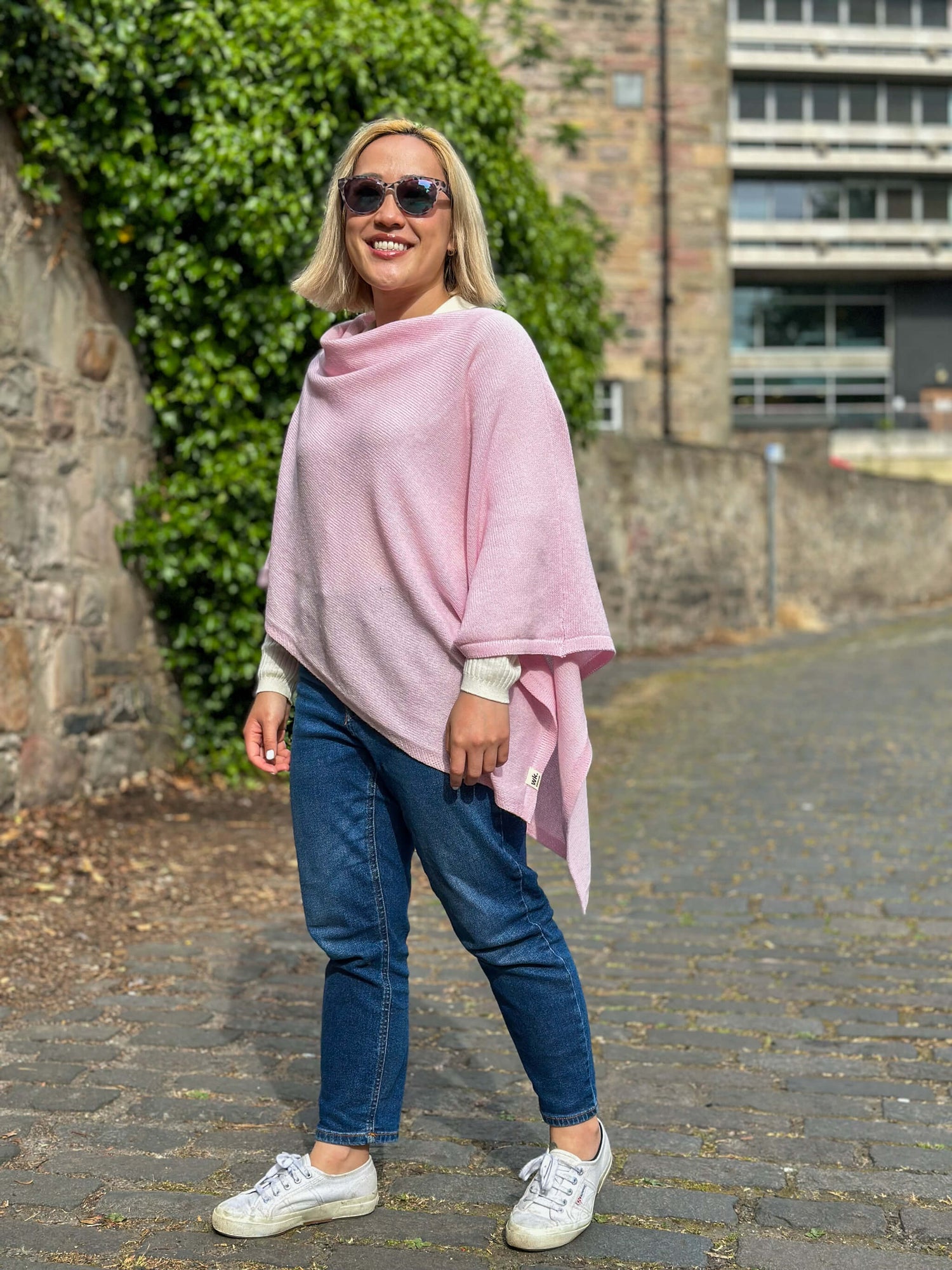 Woman wearing pink lambswool merino poncho - Woolkind