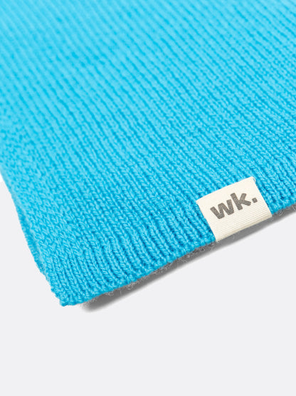 a swatch of plain single jersey knitting made from fine merino wool in a blue colour