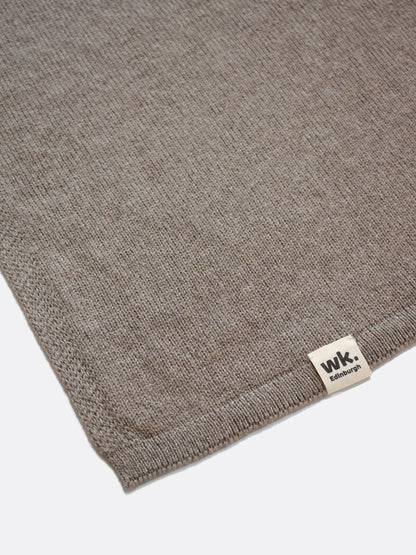 a swatch of plain single jersey knitting made from fine merino wool in a medium brown colour