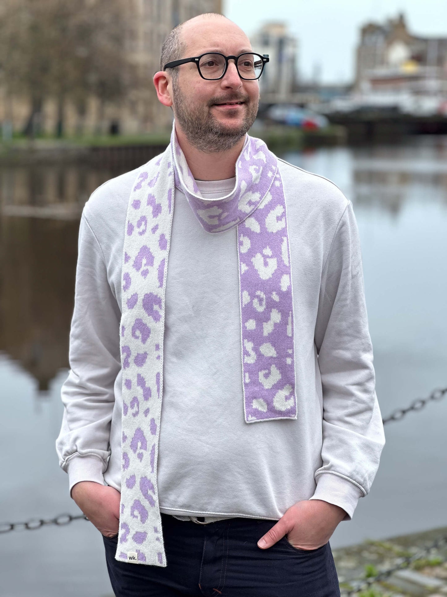 white man wearing a lilac and cream skinny merino wool leopard print scarf - Woolkind
